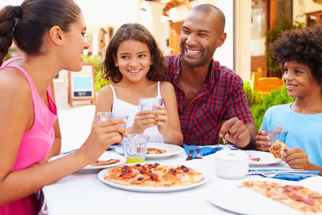 Black American family eating at restaurant and being careful with allergens