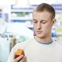 Young man looking at his pharmacy prescription