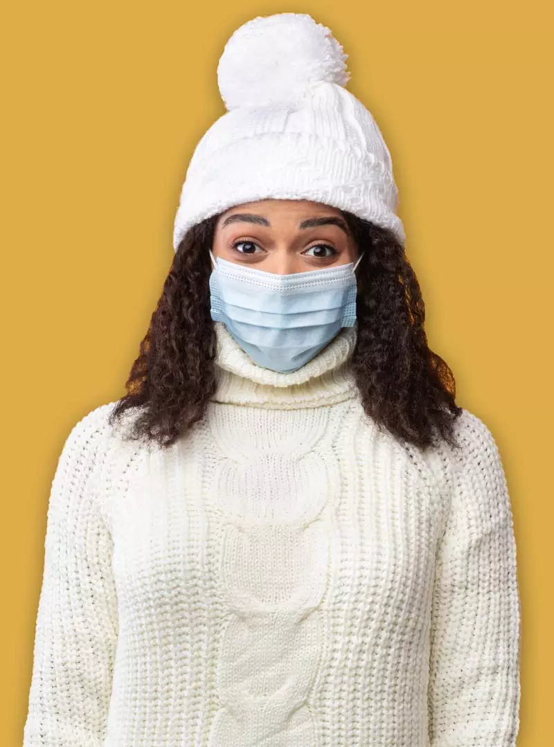 Photo of Black woman wearing a medical mask. She