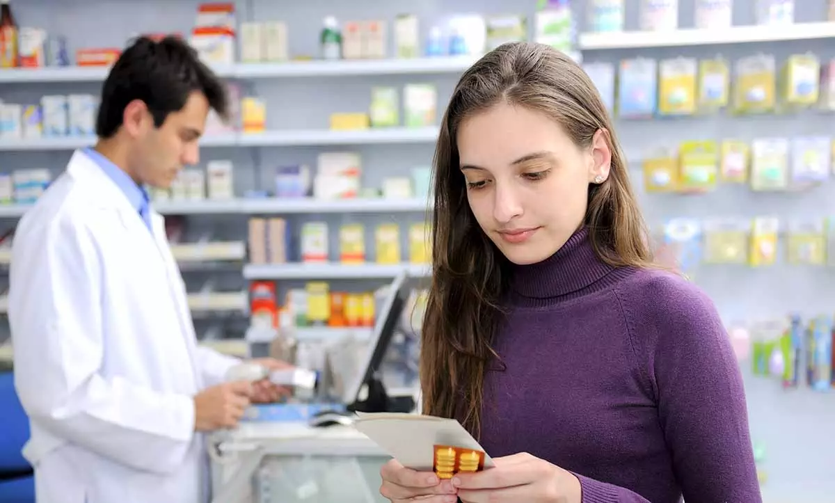 Photo of Consumer with medicine at pharmacy