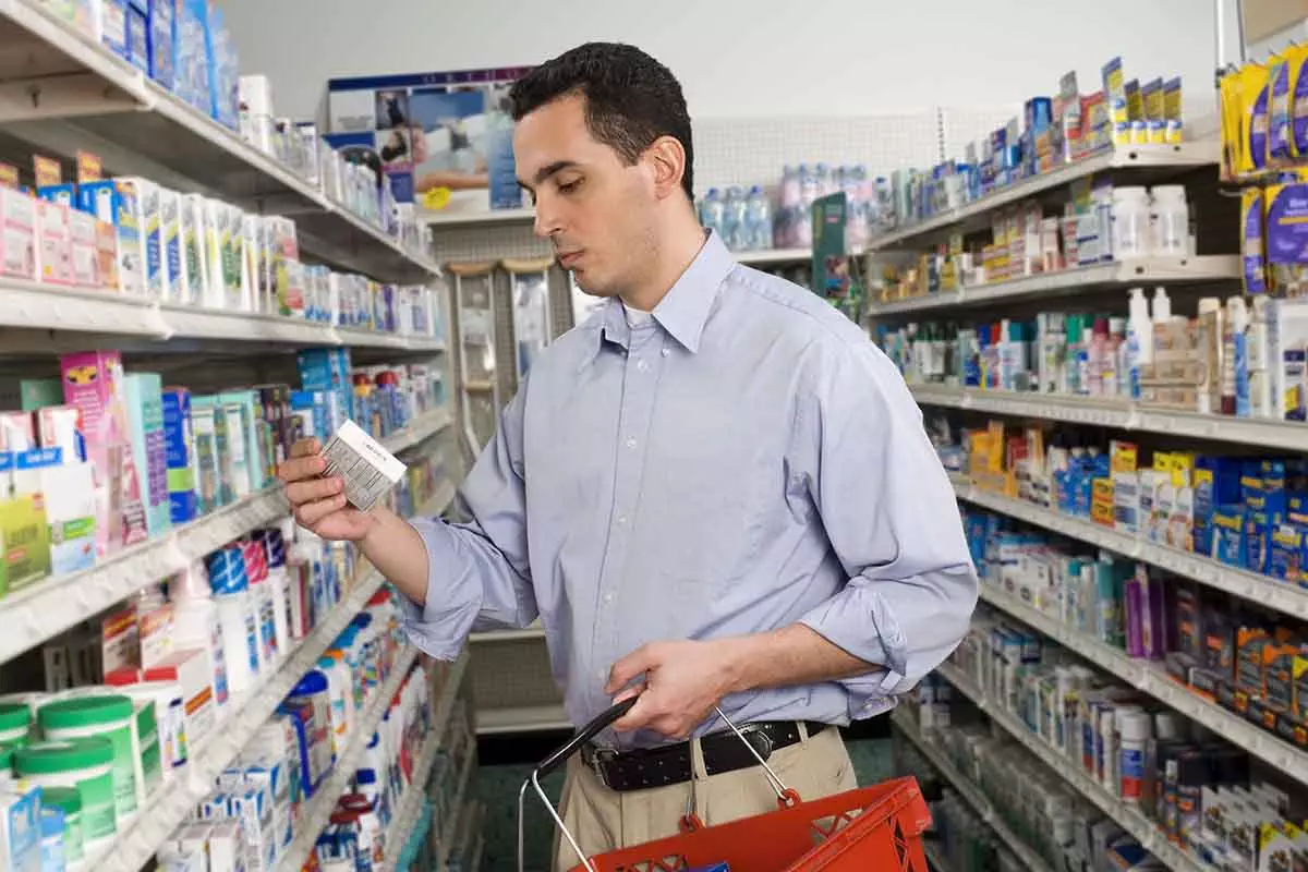 Photo of Customer looking at medication box