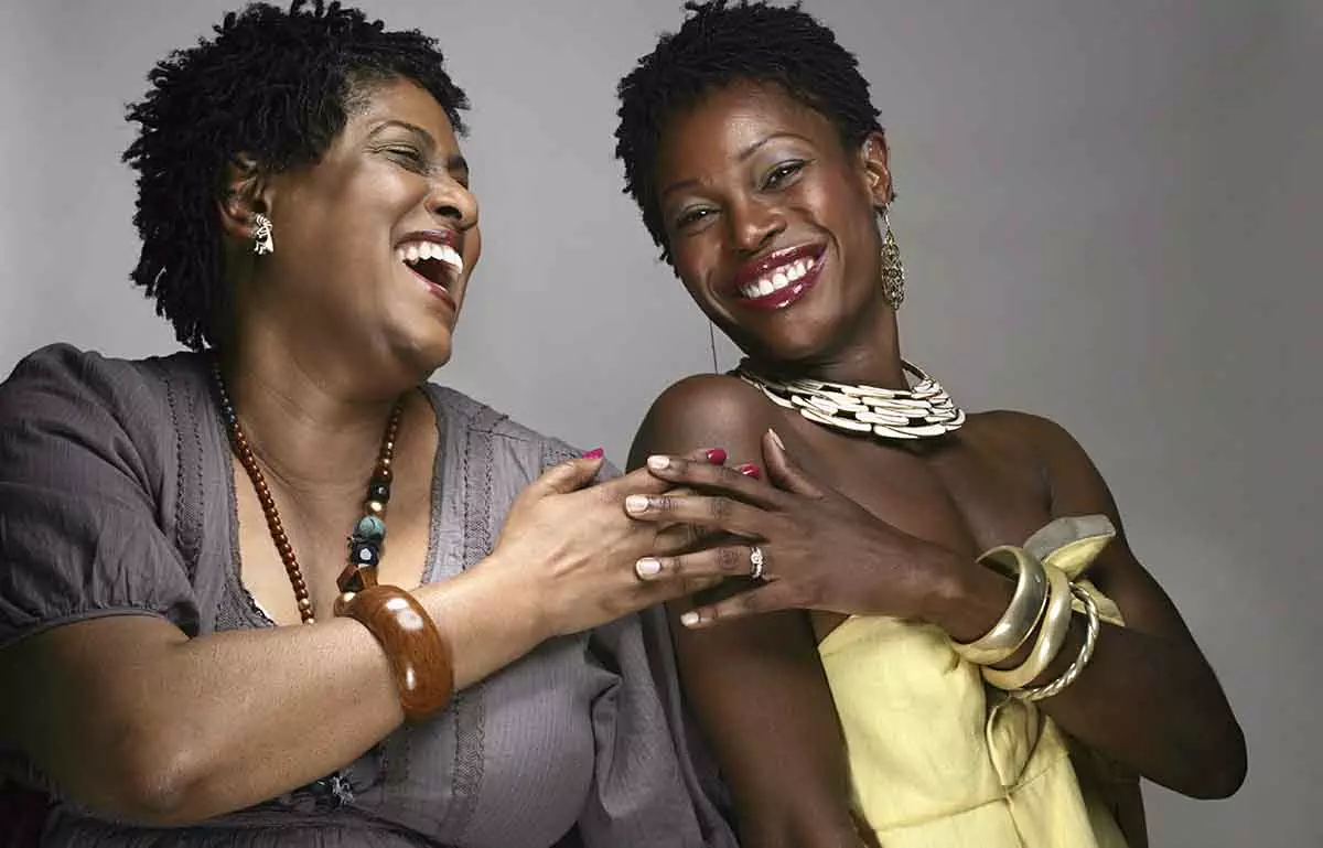 Portrait of happy mature and young African American women, studio shot