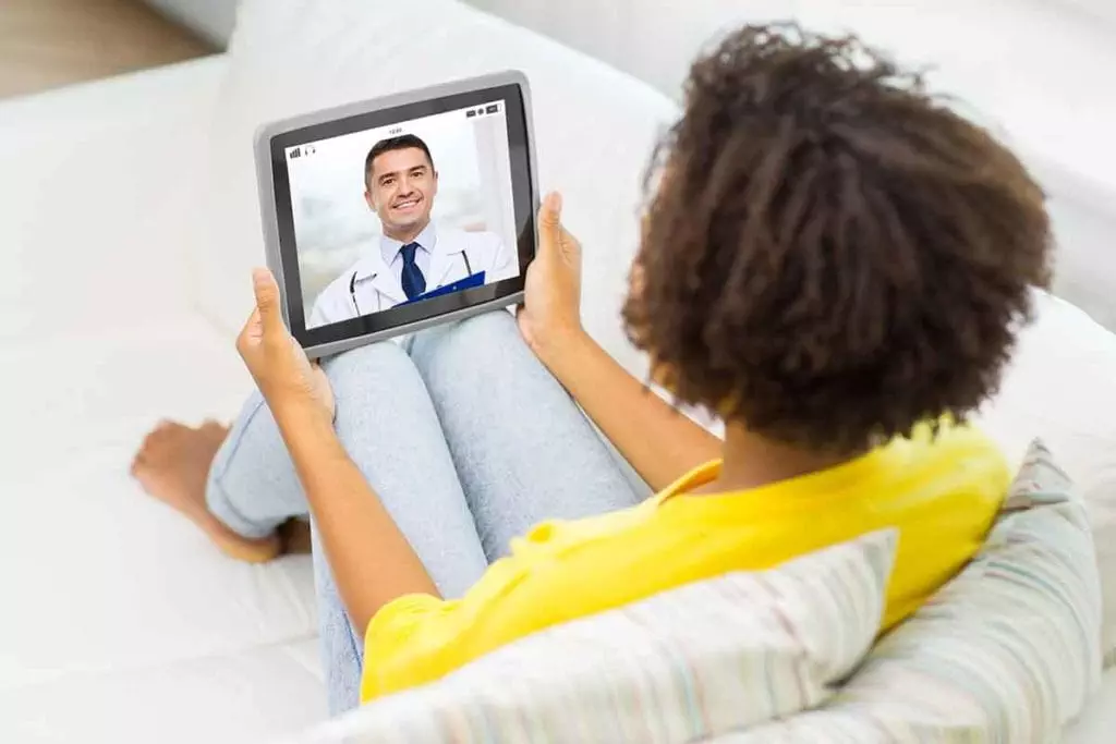 Photo of woman talking to doctor on computer