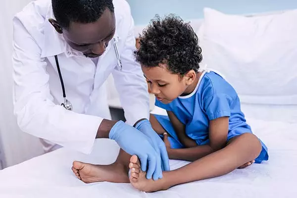 Doctor examining ethnic child