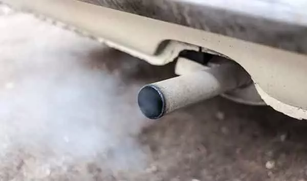 Photo of Combustion fumes coming out of car exhaust pipe
