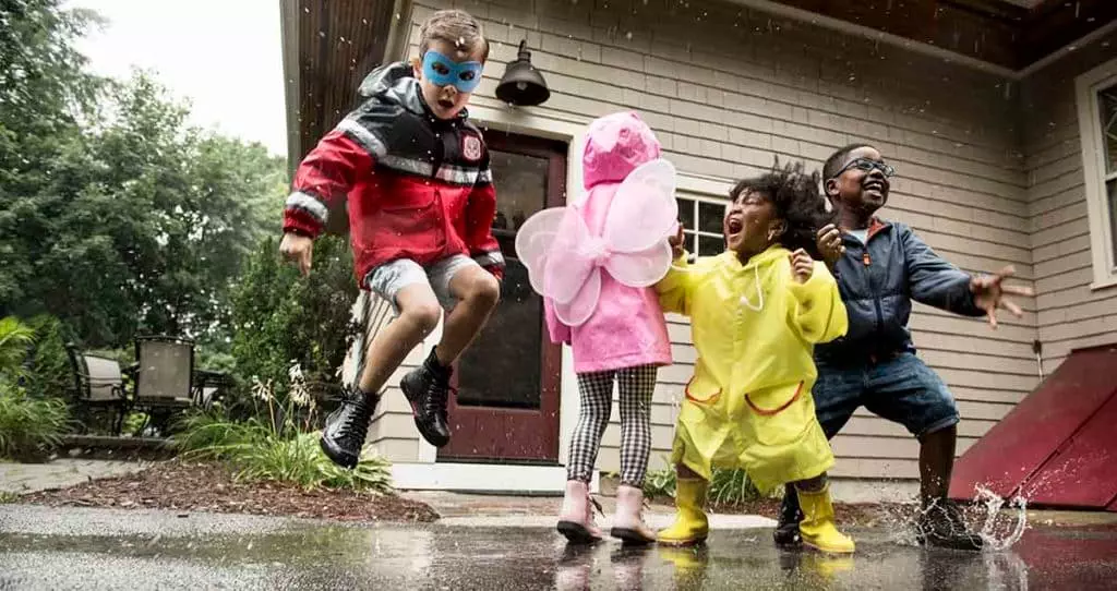 Photo of children playing in the rain