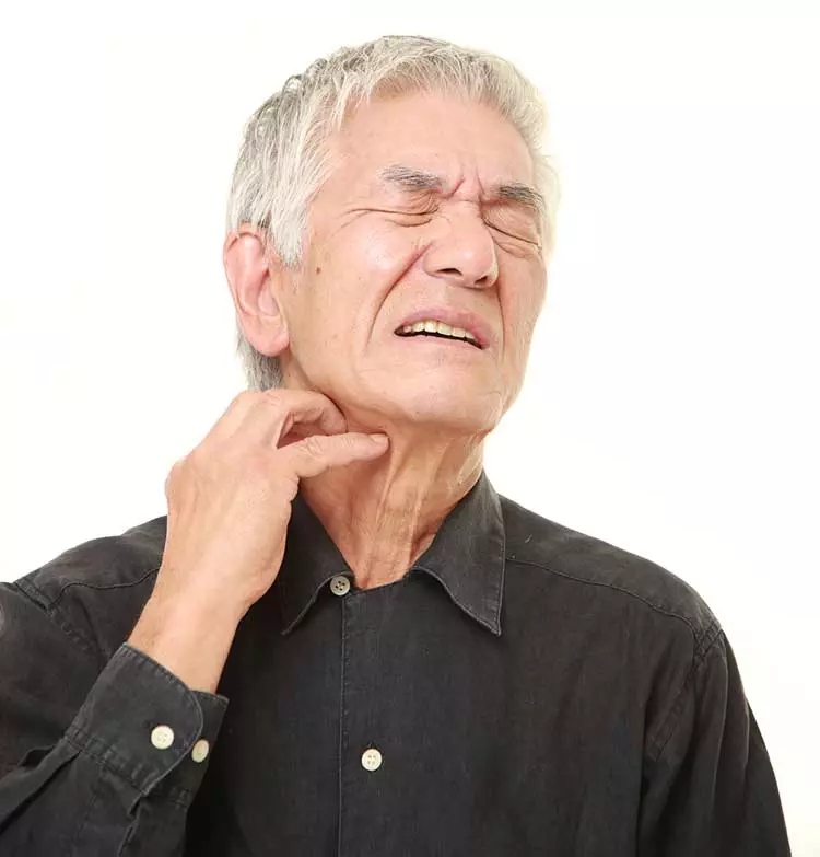 Photo of older Asian man scratching his neck because of allergies.