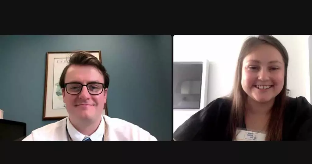 Two people on a zoom meeting. Caption below.