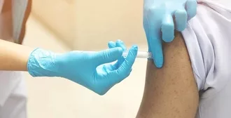Tightly cropped image of a nurse giving a person a pneumonia shot.