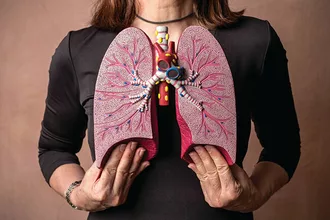 image of woman holding up medical 3d lungs