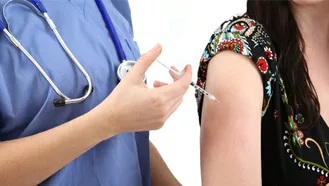 photo of nurse giving a person a shot in the arm