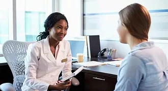 Photo of young-doctor-talking-to-patient