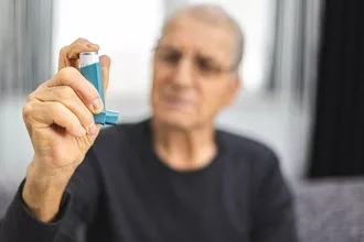 Photo of elderly Man with asthma inhaler