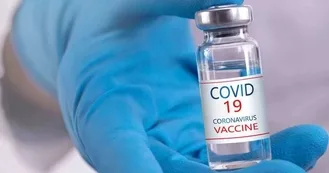 Photo of CoVID-19 vaccine medication bottle