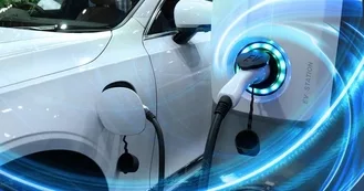 Photo of EV Car or Electric vehicle at charging station with the power cable supply plugged in on blurred nature with blue enegy power effect. Eco-friendly sustainable energy concept.