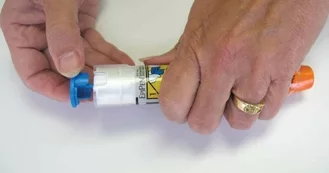 Woman's hands opening epinephrine autoinjector case