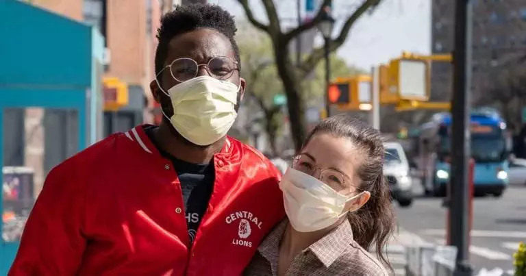 Photo of multiracial couple wearing face masks