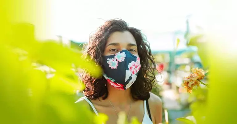 Photo of woman in a garden wearing a mask